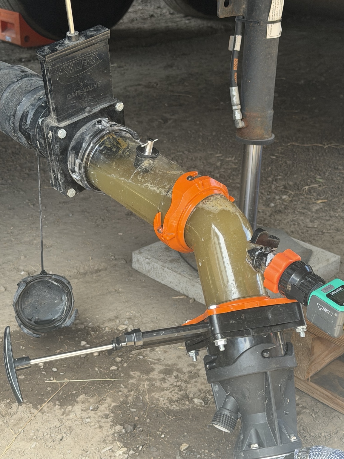 Wastewater visible through clear RV fitting during cleaning